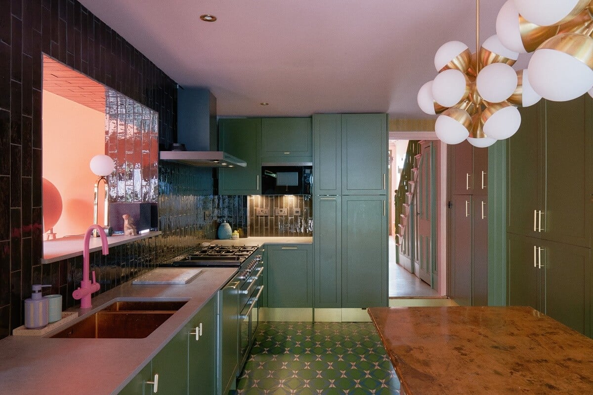 A Fun Colorful Family House in England 14 green-kitchen-cabinets-and-tiles-pink-faucet-nordroom