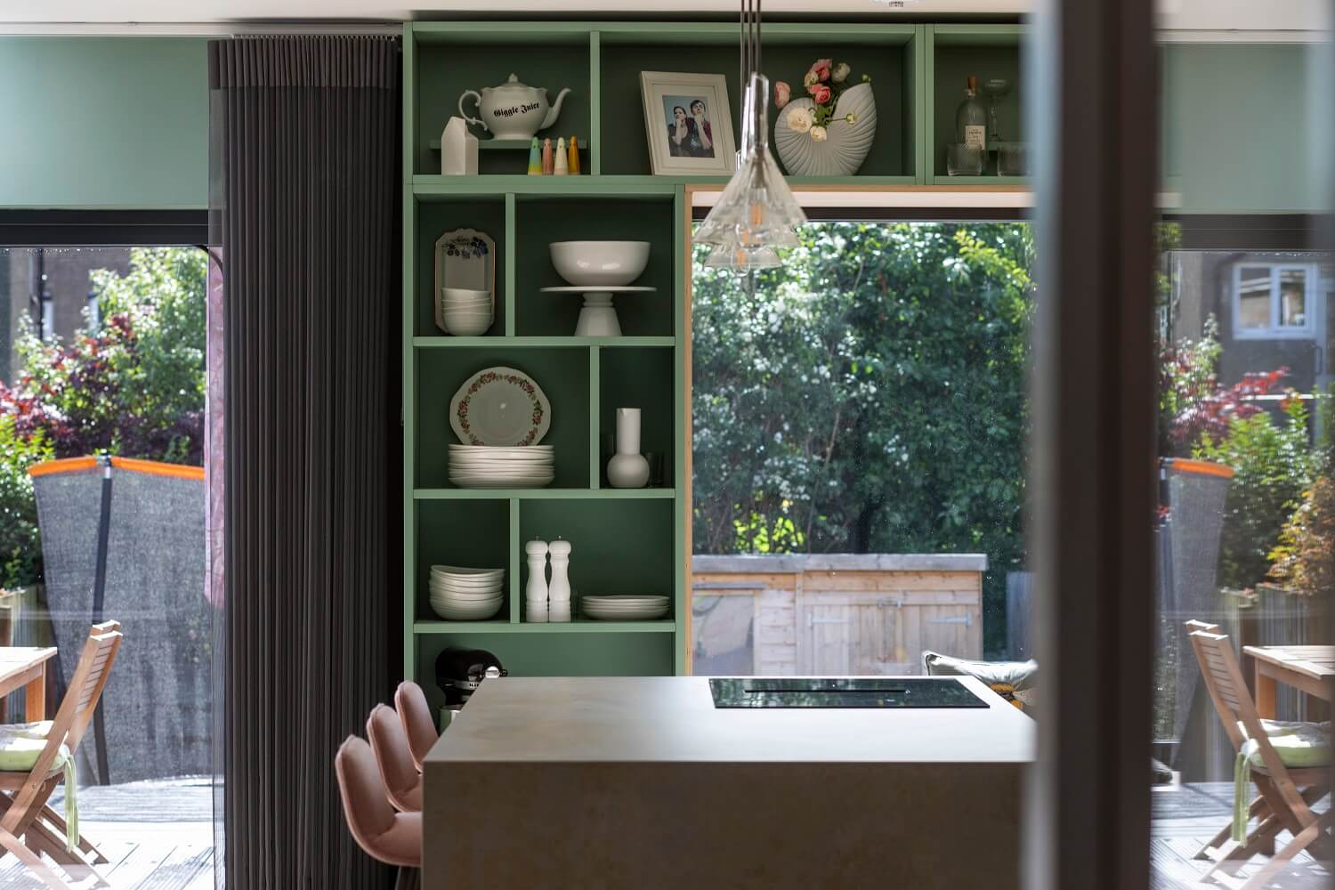 An Open-Plan Living and Kitchen in Green and Pink Tones 6 green-open-cabinets-around-window-agora-architecture-design-nordroom