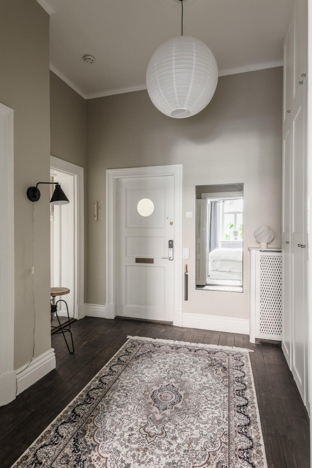 A Dark Gray Painted Ceiling in a Scandi Apartment 22 hallway-light-gray-walls-rug-nordroom