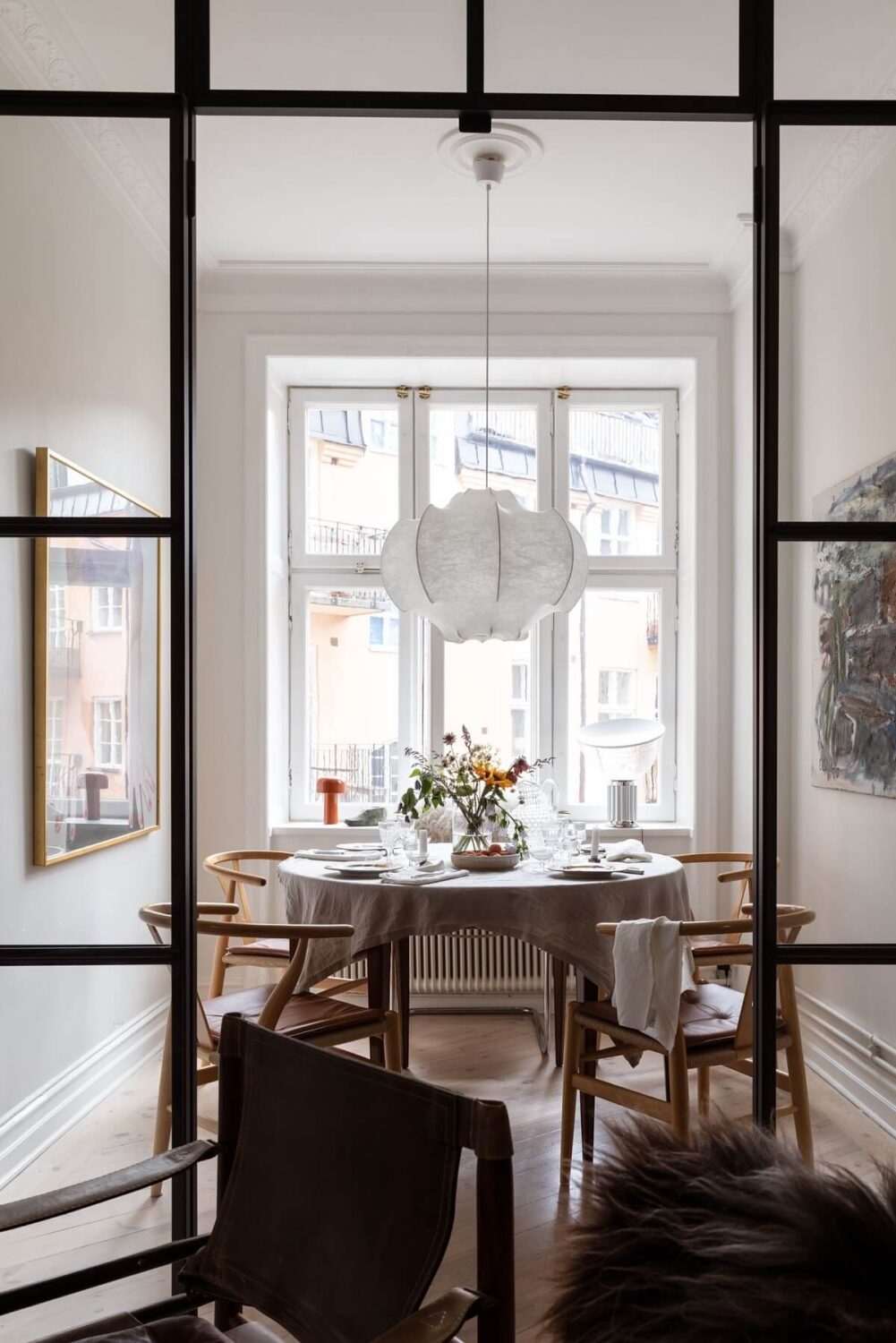 A Light Swedish Apartment with an Industrial Glass Wall 6 industrial-glass-wall-dining-room-nordroom