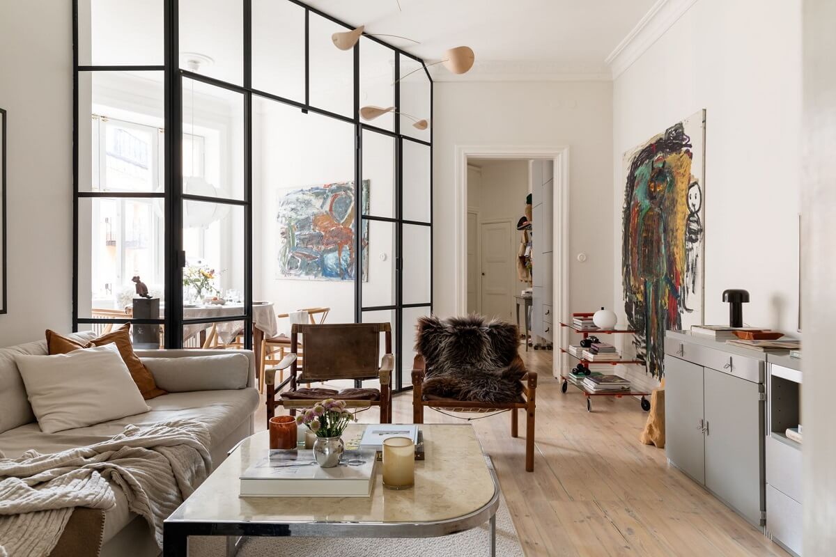 A Light Swedish Apartment with an Industrial Glass Wall 1 industrial-glass-wall-living-room-nordroom