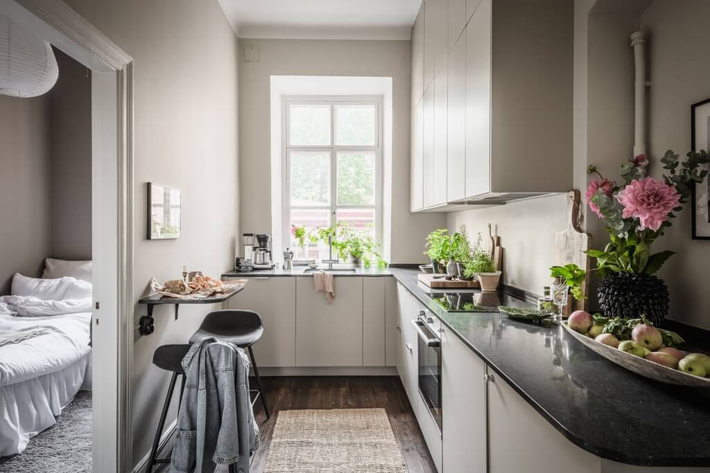 A Dark Gray Painted Ceiling in a Scandi Apartment 19 kitchen-light-gray-walls-small-bar-table-nordroom