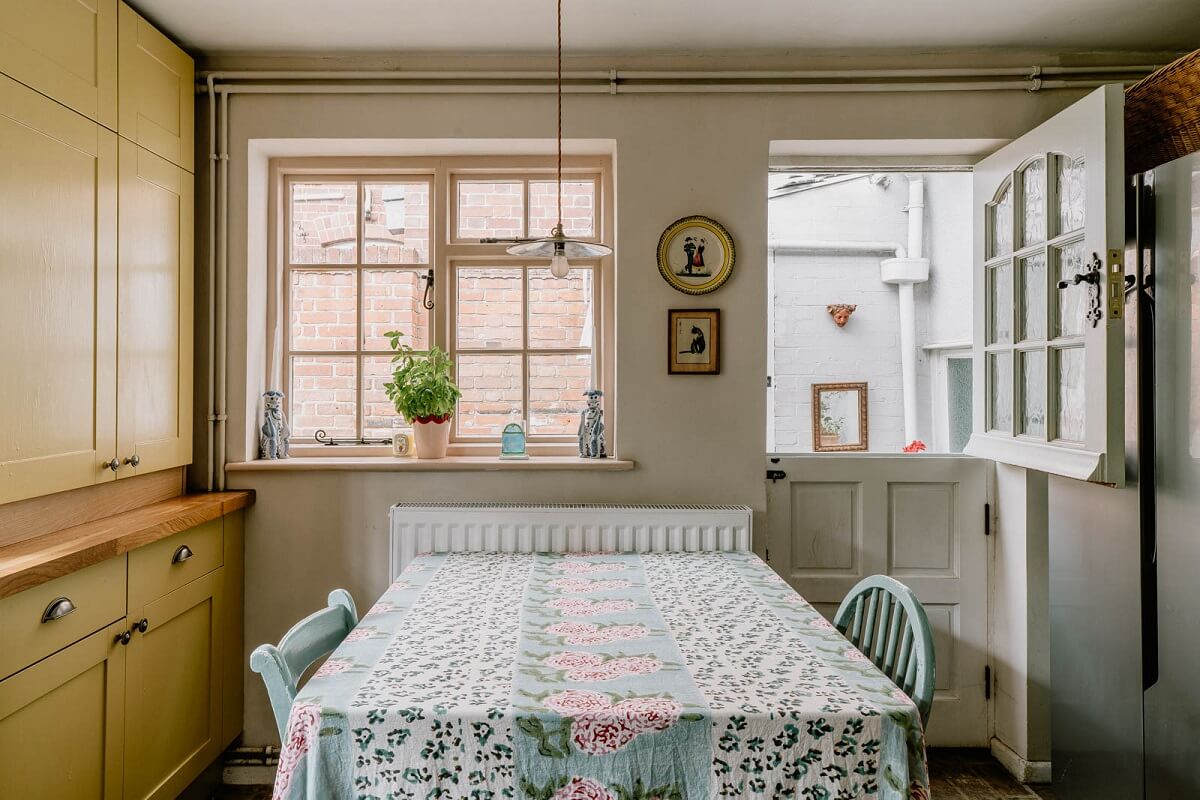 A Charming English Cottage with Color Accents 13 kitchen-table-yellow-cabinets-nordroom