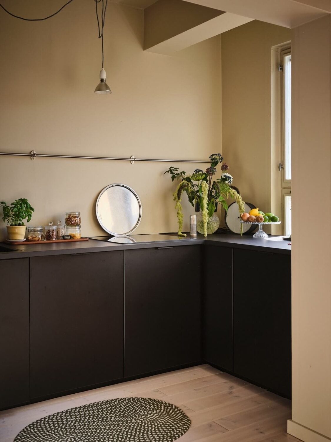 A Serene Beige Apartment with Two Balconies 11 kitchen-with-modern-black-cabinets-nordroom