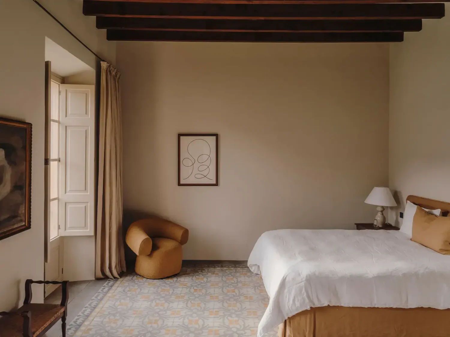 A Historic Townhouse on Majorca with a Striped Pool 14 large-bedroom-tiles-wooden-ceiling-beams-nordroom