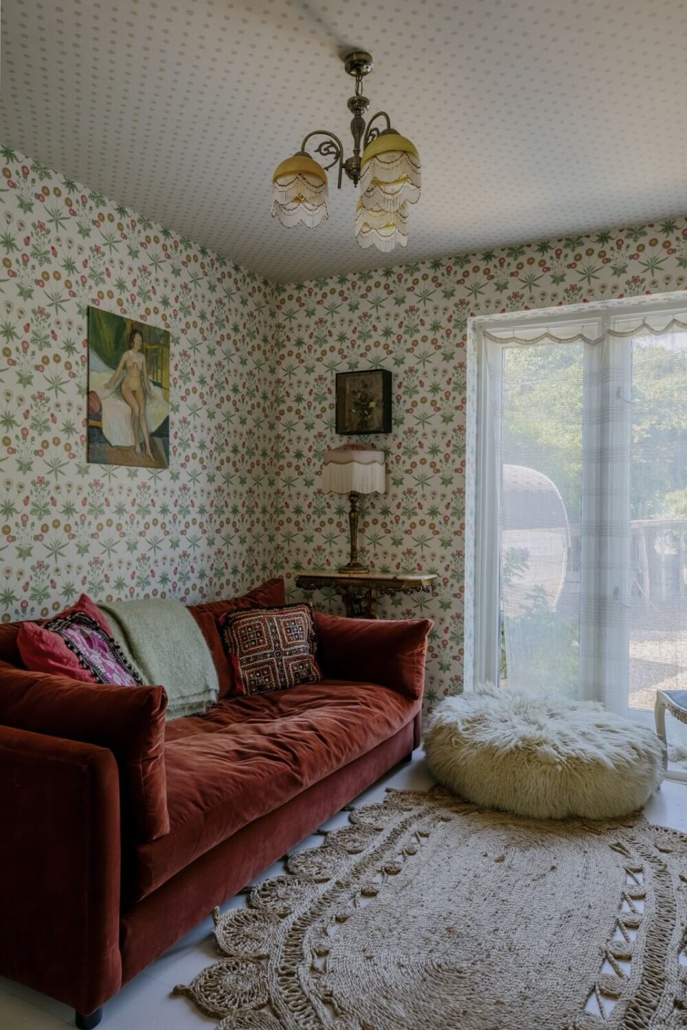 Pearl Lowe's Vintage Boho English Beach House is For Sale 10 living-room-red-sofa-wallpaper-nordroom