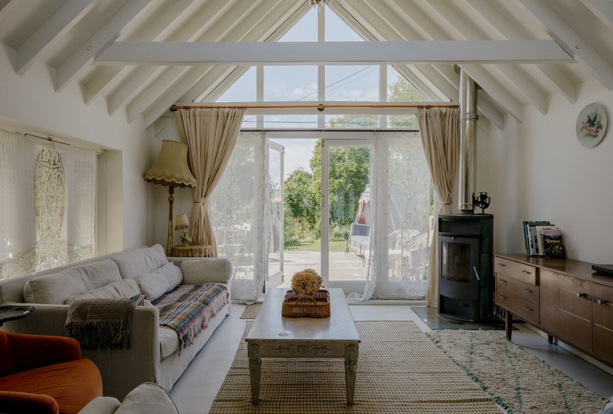 Pearl Lowe's Vintage Boho English Beach House is For Sale 9 living-room-vaulted-ceiling-wooden-beams-beach-house-nordroom