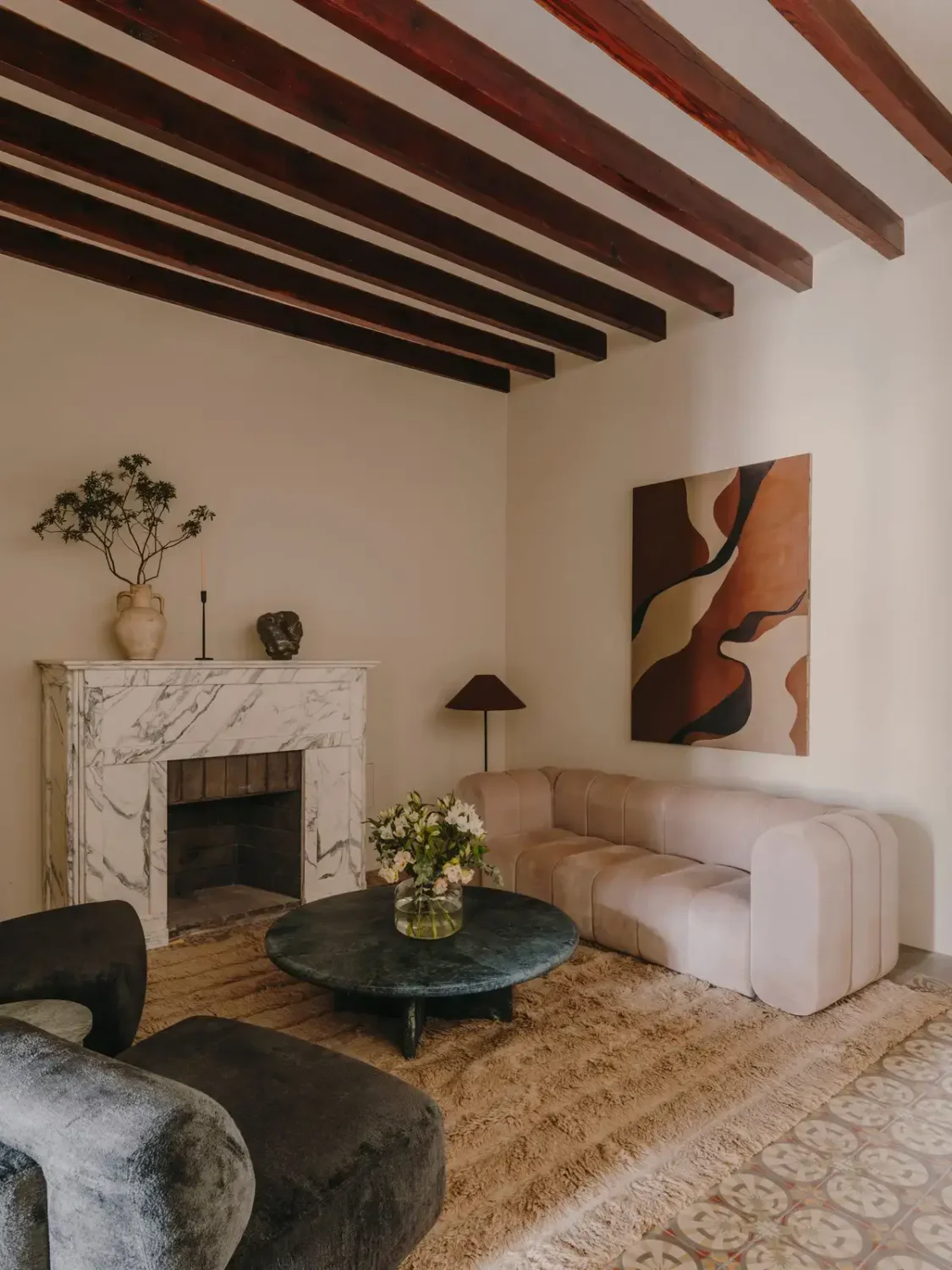 A Historic Townhouse on Majorca with a Striped Pool 8 living-room-with-exposed-beams-marble-fireplace-nordroom