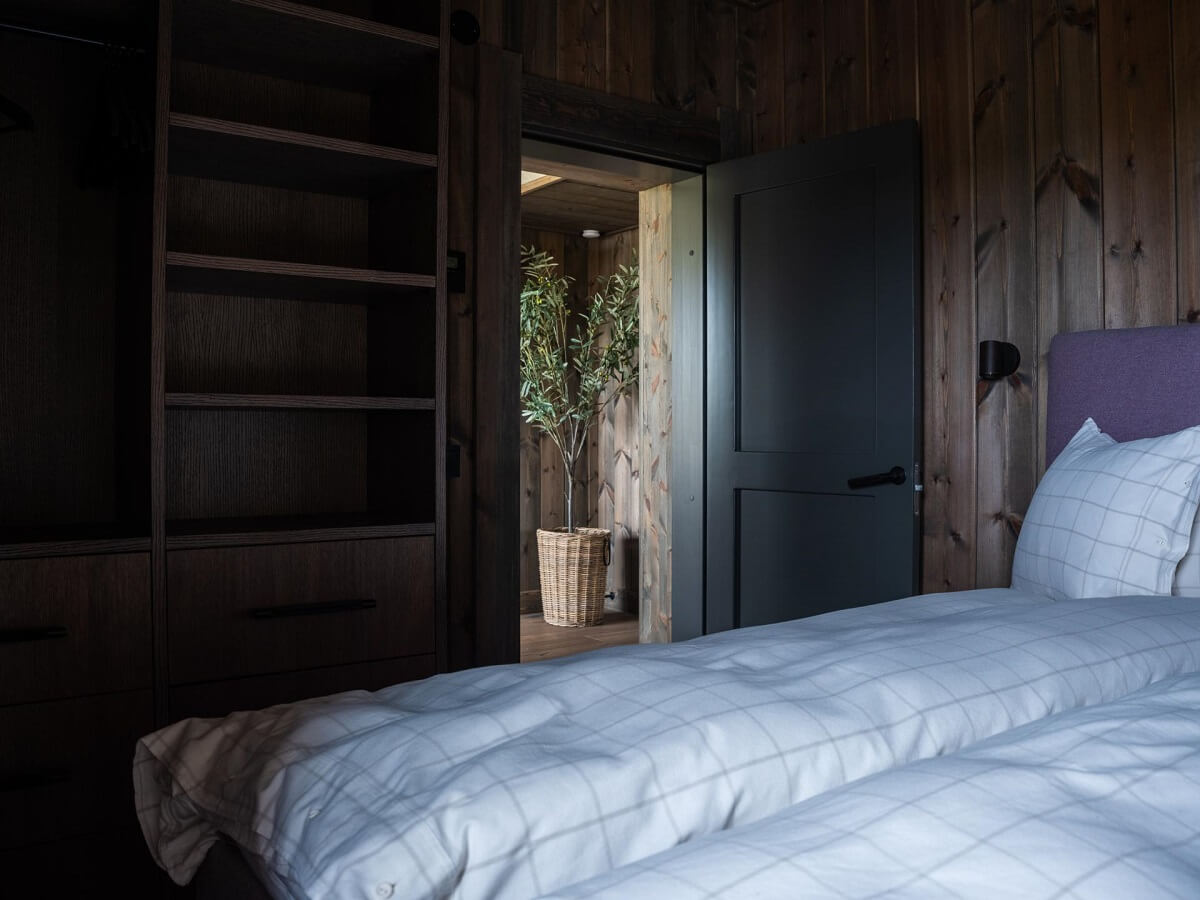 A Modern Rustic Log House in Sweden 13 log-house-bedroom-built-in-wardrobes-nordroom
