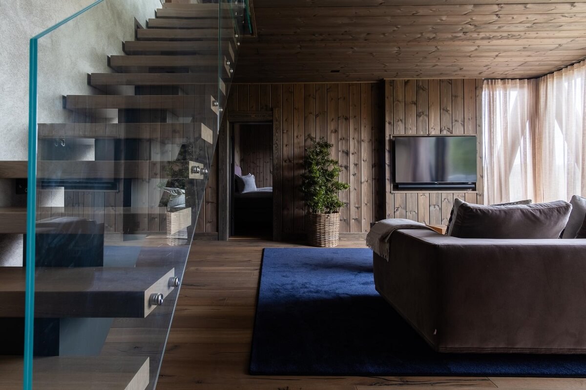A Modern Rustic Log House in Sweden 9 log-house-living-room-blue-rug-nordroom