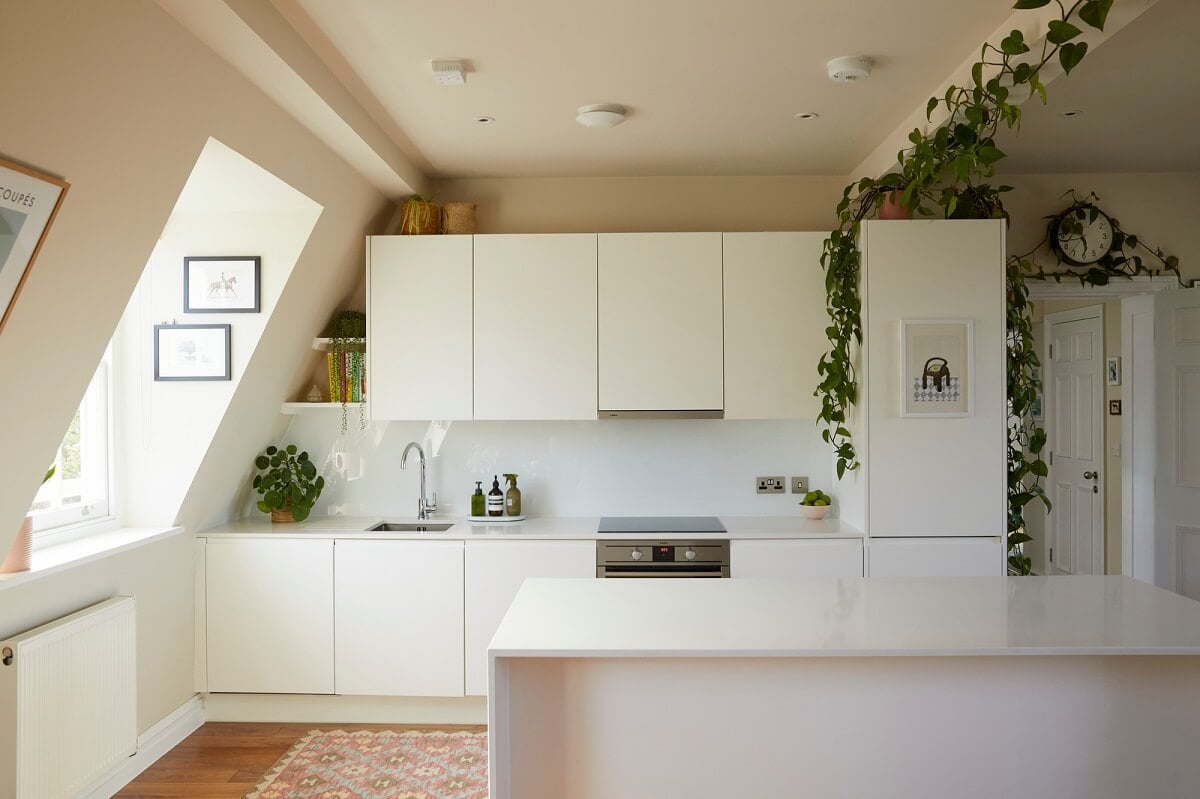 A Light Attic Apartment in London 4 modern-white-kitchen-with-island-hanging-plants-nordroom