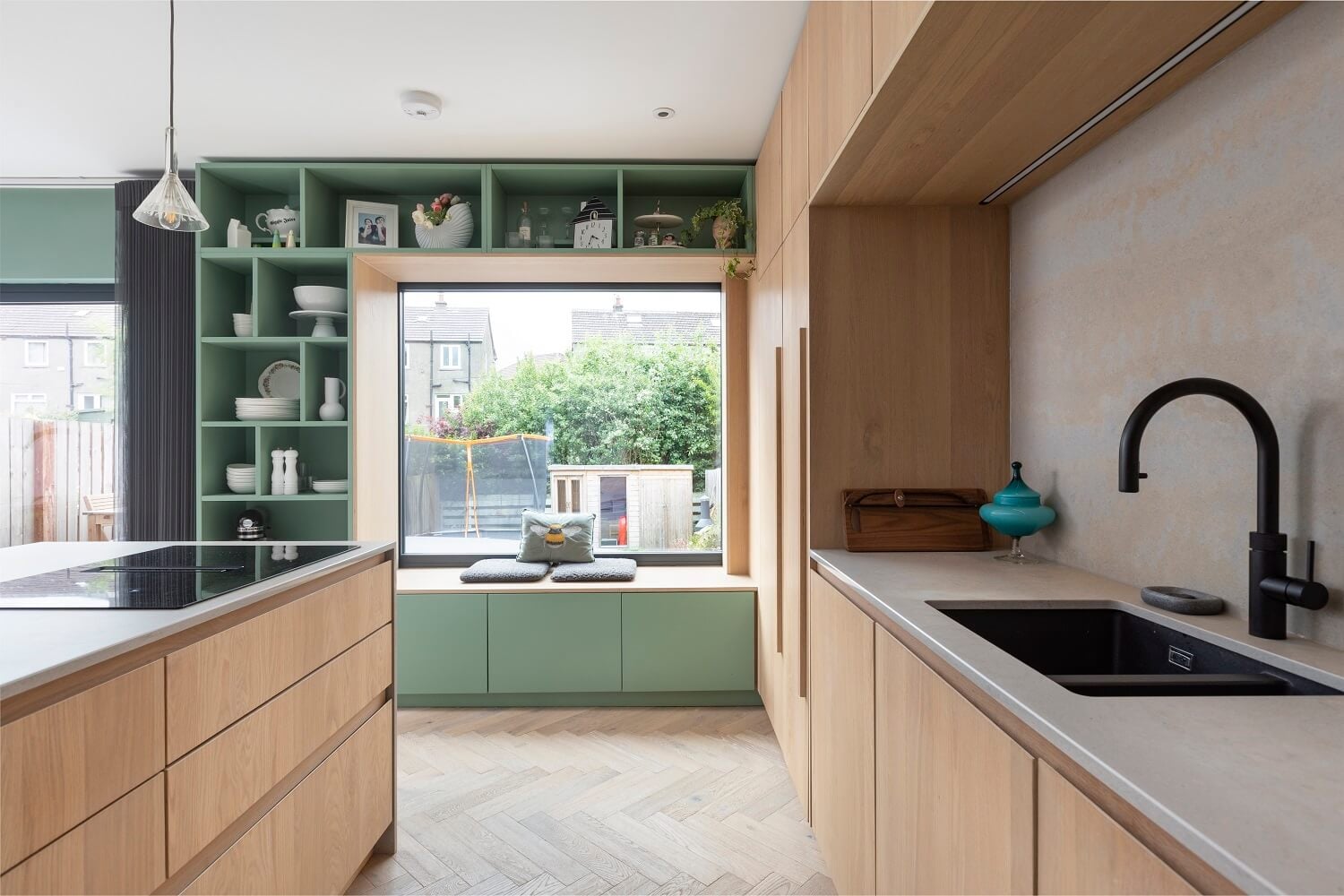 An Open-Plan Living and Kitchen in Green and Pink Tones 5 oak-kitchen-cabinets-green-window-seat-with-storage-nordroom