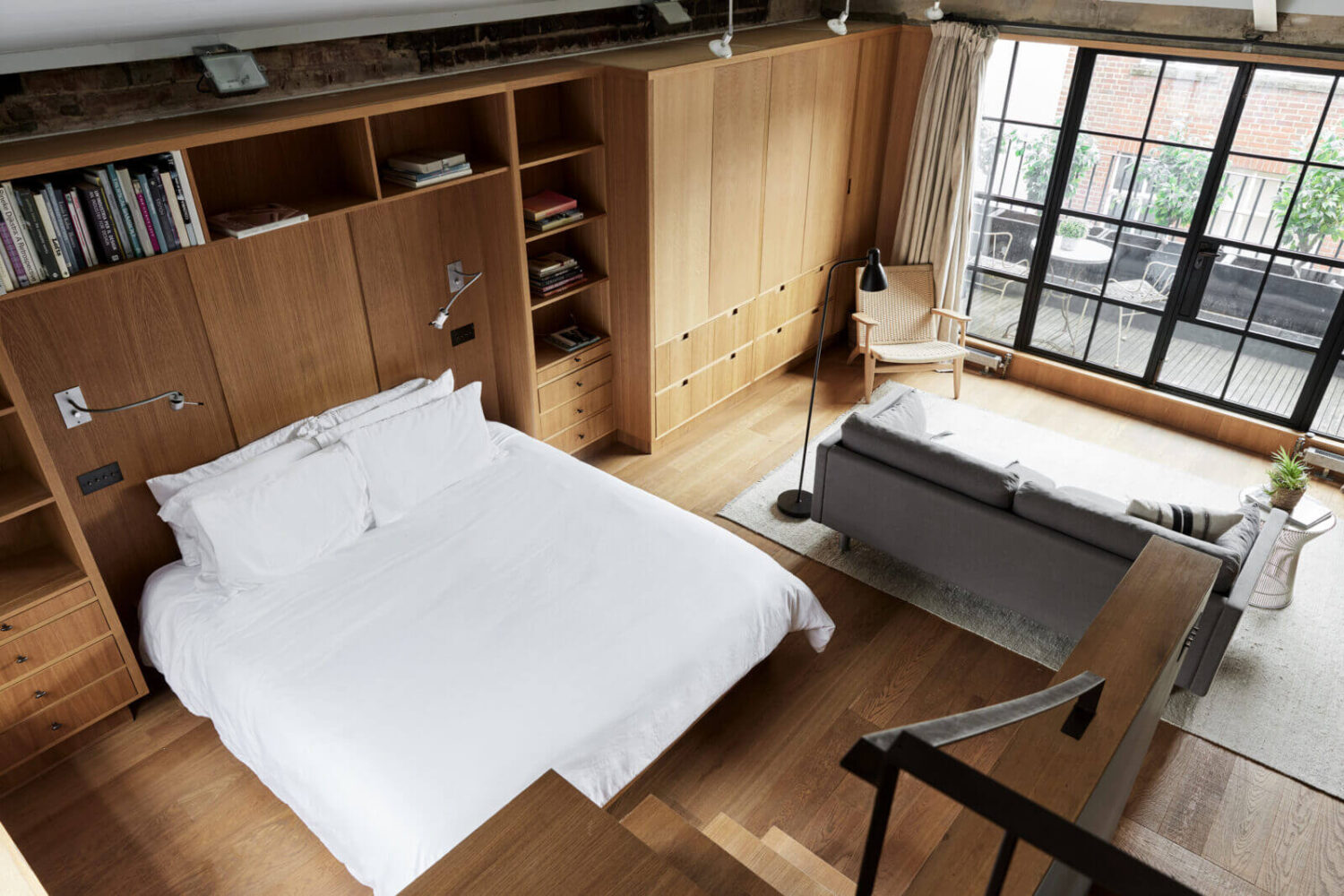 A Modern London Home with Custom Built Oak Furniture 15 open-plan-bedroom-with-seating-area-built-in-oak-furniture-nordroom