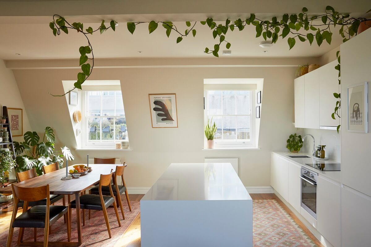 A Light Attic Apartment in London 5 open-plan-kitchen-dining-room-white-cabinets-plants-on-ceiling-nordrom