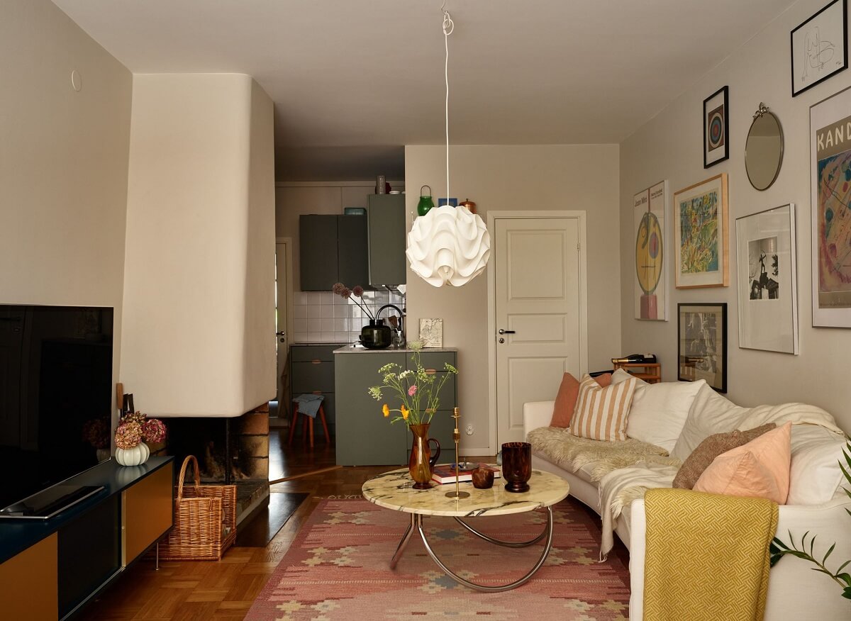 A Scandinavian Apartment with a Fresh Blue Bedroom 6 open-plan-living-room-kitchen-pink-rug-nordrom