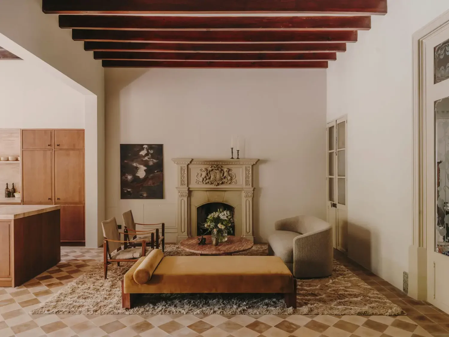 A Historic Townhouse on Majorca with a Striped Pool 5 open-plan-living-space-floor-tiles-wooden-beams-ohre-yellow-bench-nordroom