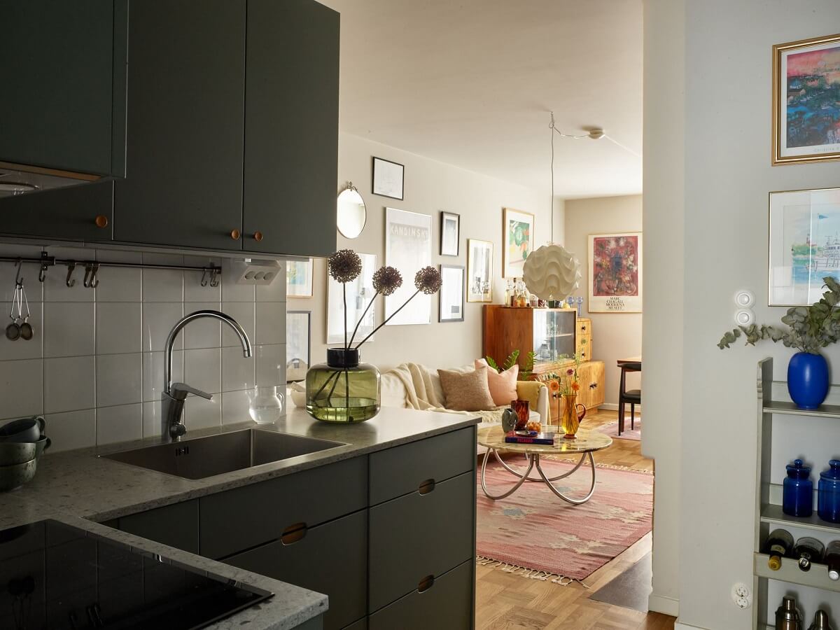 A Scandinavian Apartment with a Fresh Blue Bedroom 10 open-plan-living-space-green-kitchen-cabinets-nordroom