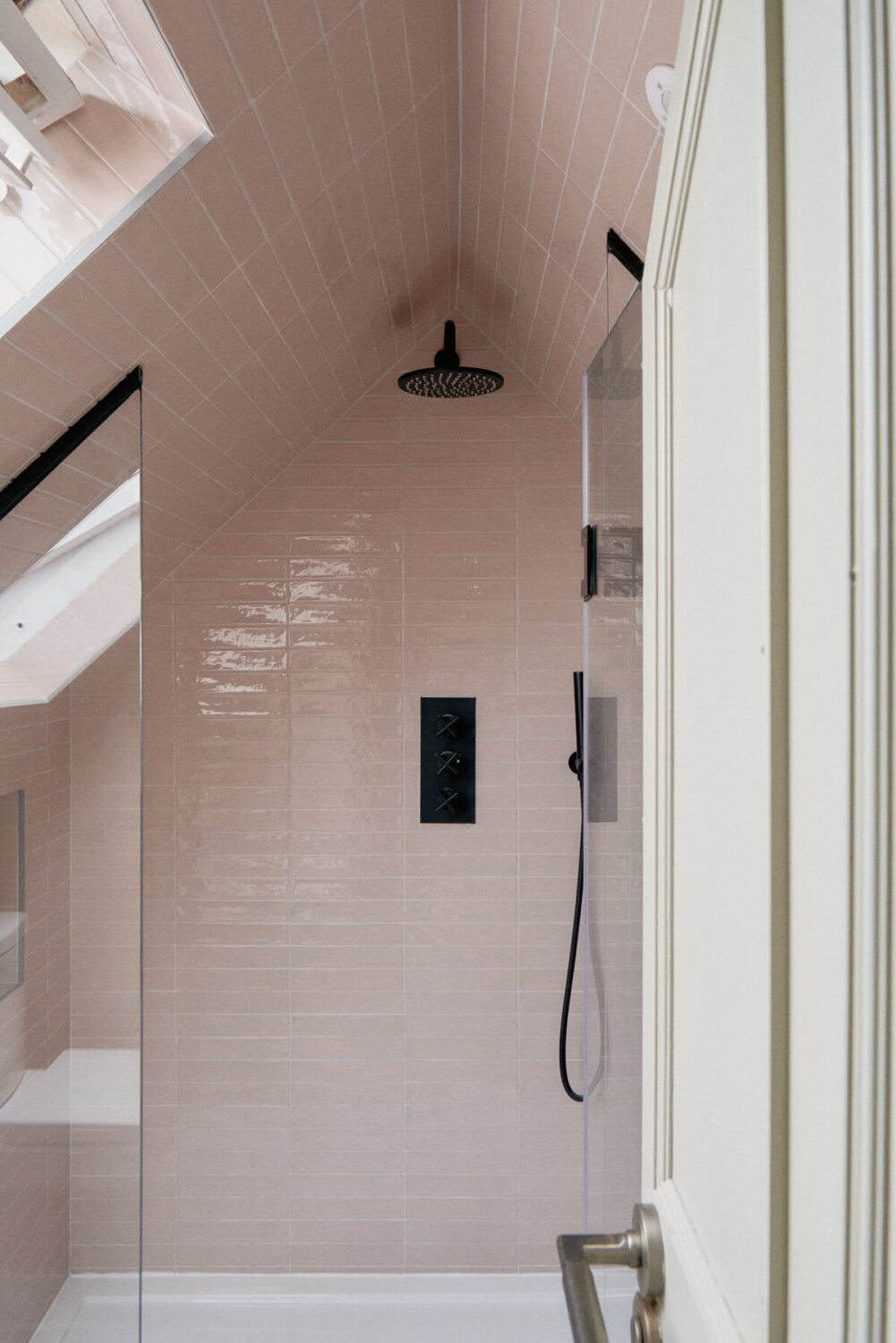 A Fun Colorful Family House in England 32 pink-shower-tiles-black-fitting-slanted-ceiling-nordroom