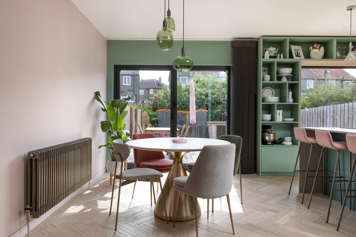An Open-Plan Living and Kitchen in Green and Pink Tones 8 round-dining-table-green-pink-open-plan-living-kitchen-agora-nordroom