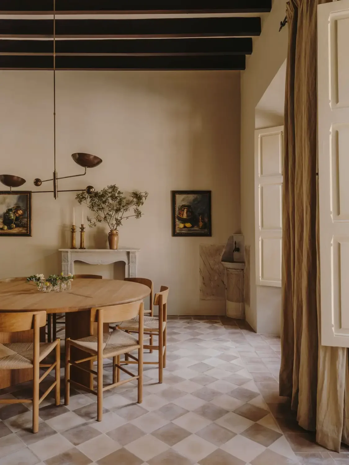 A Historic Townhouse on Majorca with a Striped Pool 1 round-dining-table-historic-checkerboard-tiles-nordroom