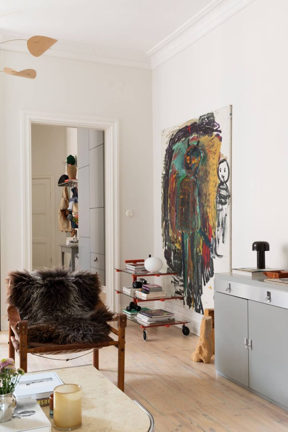 A Light Swedish Apartment with an Industrial Glass Wall 5 scandi-living-room-large-artwork-nordroom