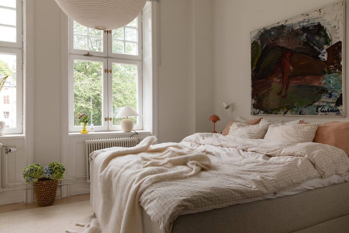 A Light Swedish Apartment with an Industrial Glass Wall 20 serene-master-bedroom-large-artwork-nordroom