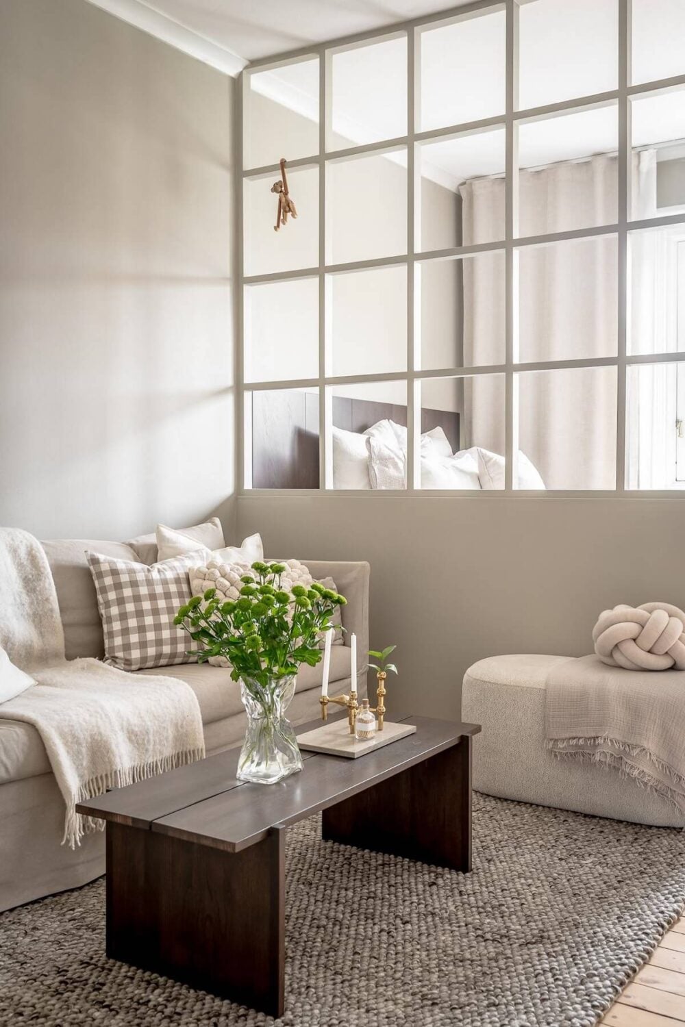 A Serene Studio Apartment with a Brown Kitchen 2 studio-apartment-half-wall-glass-room-divider-nordroom