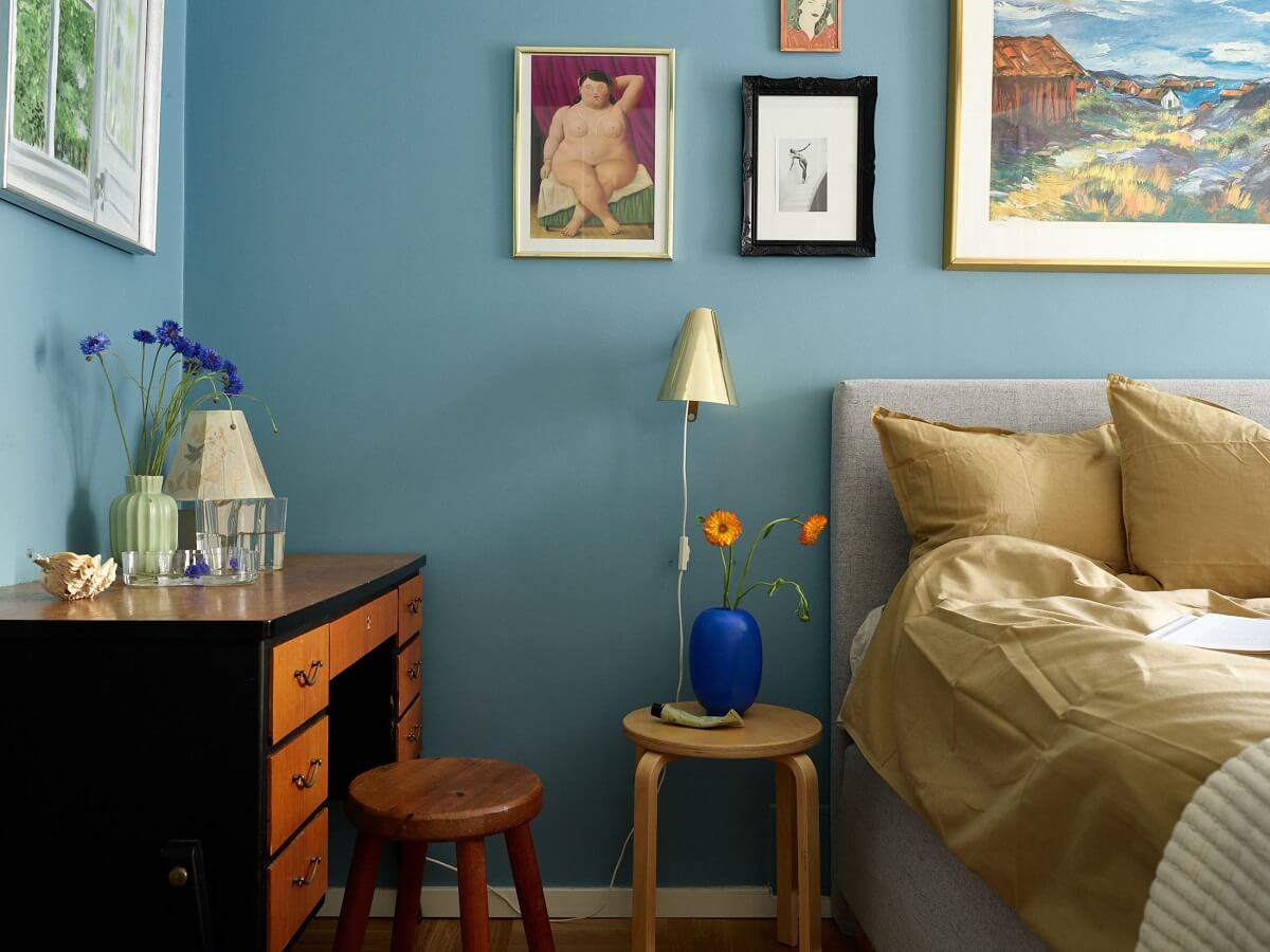 A Scandinavian Apartment with a Fresh Blue Bedroom 15 vibrant-blue-wall-paint-bedroom-yellow-bedding-desk-nordroom