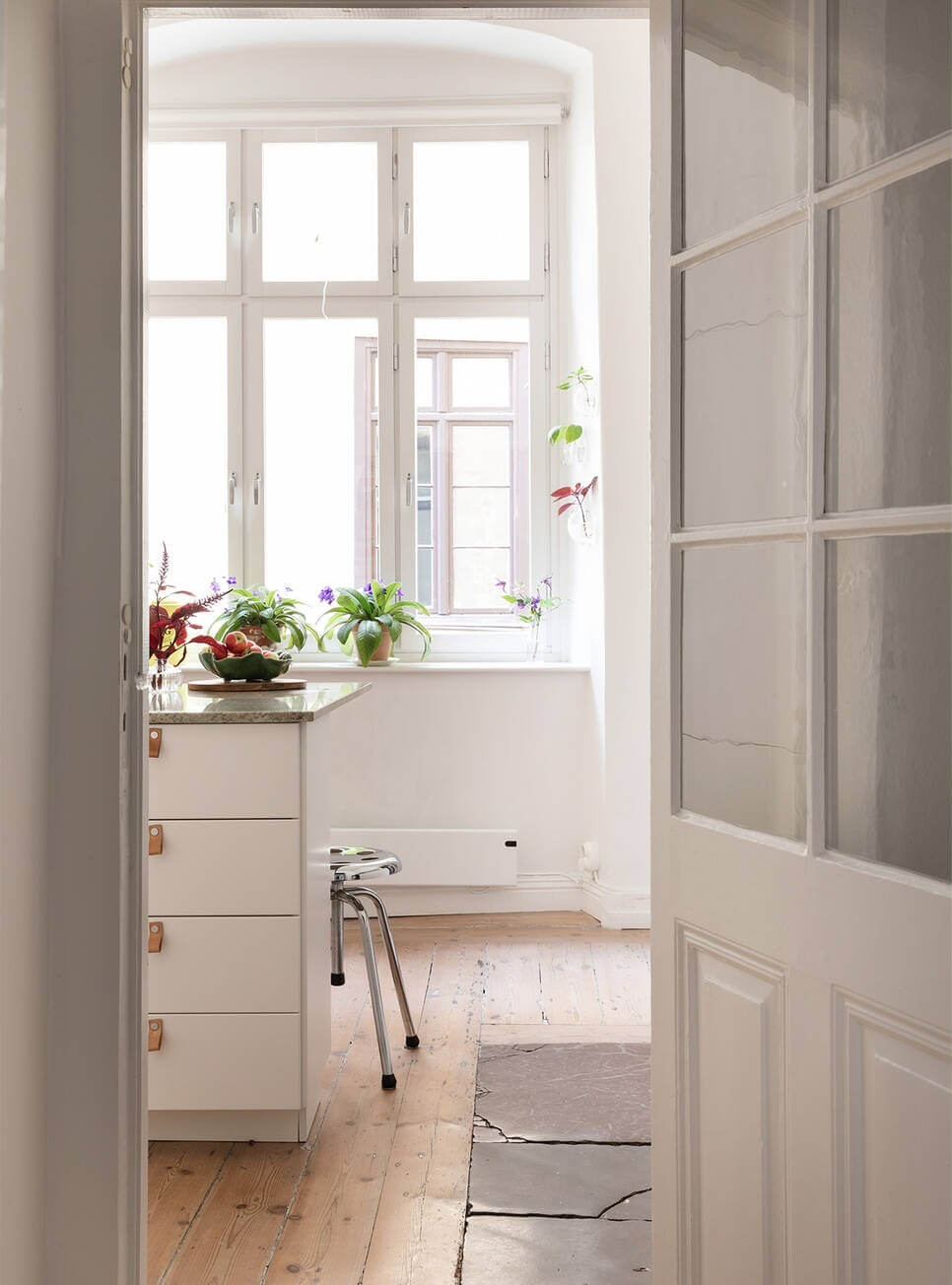 A Lovely Swedish House Revisited 10 view-into-light-kitchen-with-wooden-floor