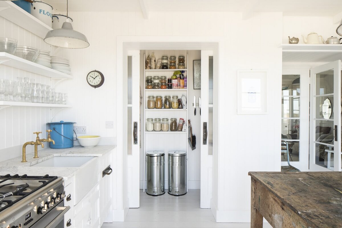 A Bright Coastal Home with Blue Color Accents in England 6 white-kitchen-with-pantry