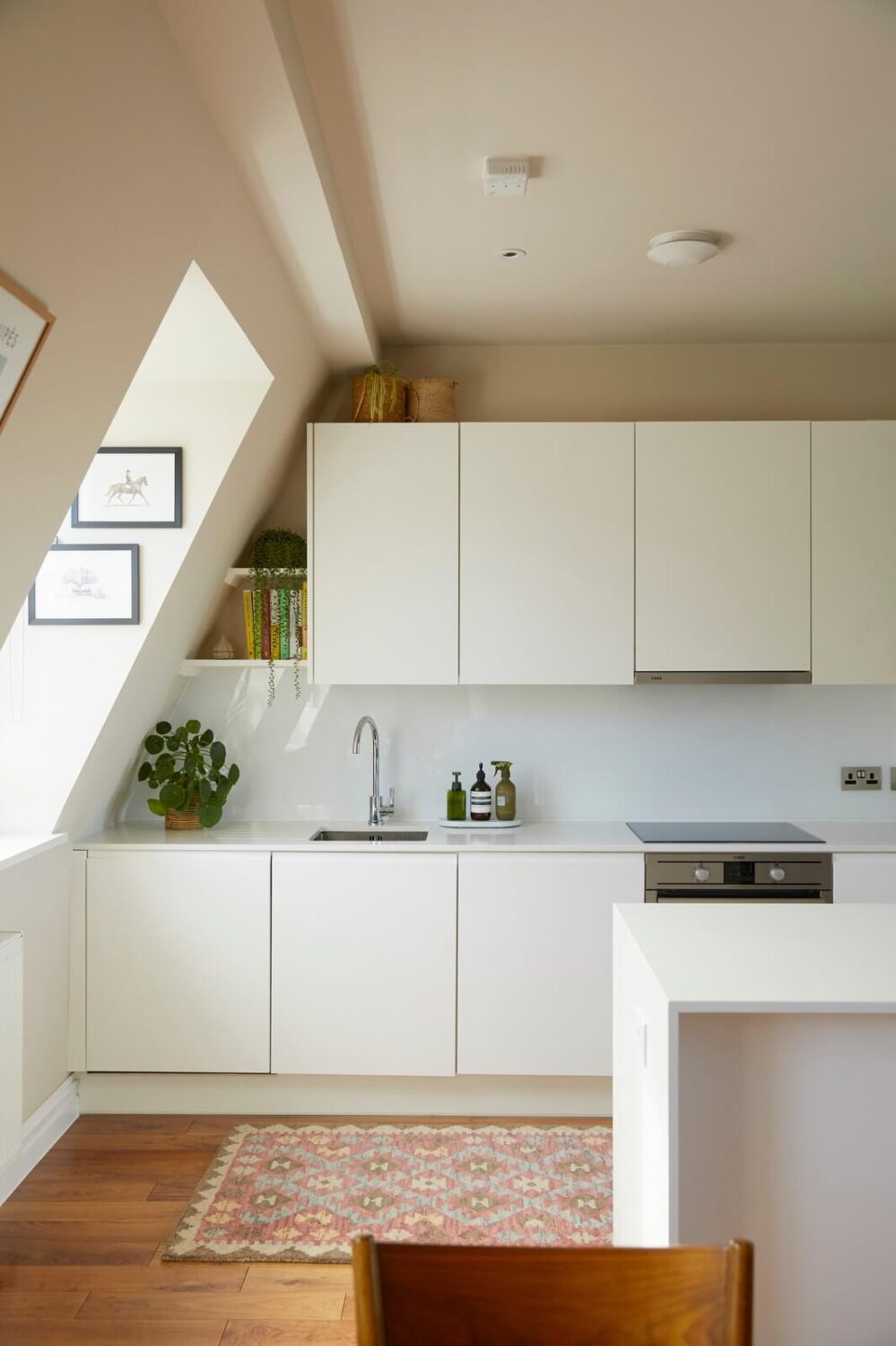 A Light Attic Apartment in London 3 white-modern-kitchen-slanted-ceiling-nordroom