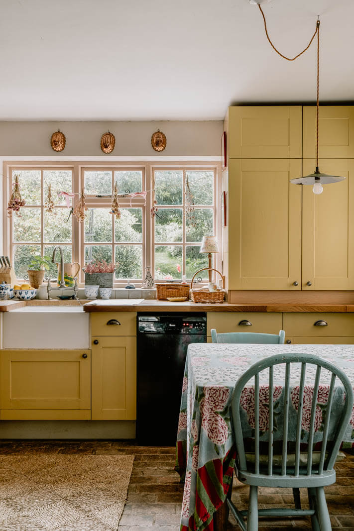 A Charming English Cottage with Color Accents 11 yellow-cabinets-english-cottage-kitchen-nordroom