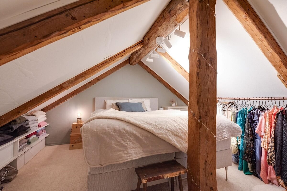 A Small 18th-Century Courtyard House in Sweden 15 attic bedroom slanted ceiling wooden beams