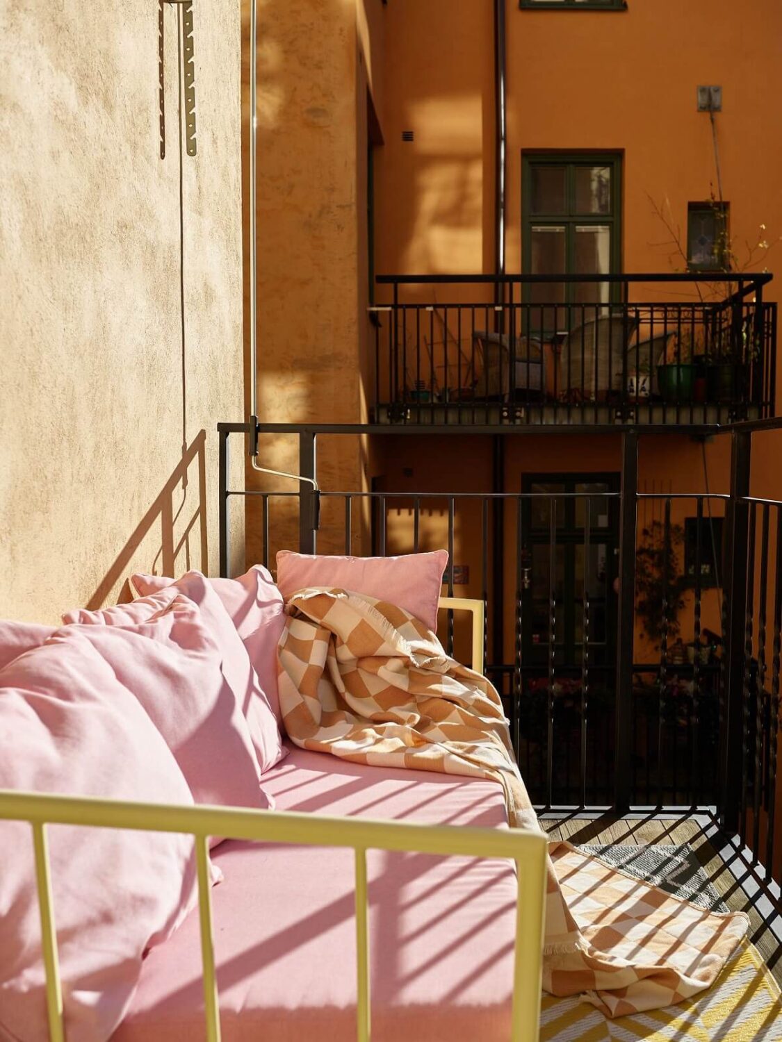 A Small Stockholm Apartment Filled with Color 18 balcony pink bench A Small Stockholm Apartment Filled with Color