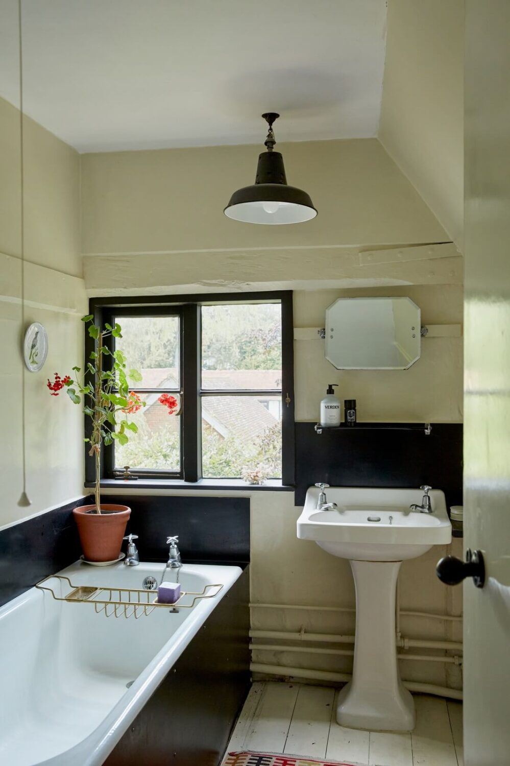 A Charming Historic Farmhouse with a Bright Yellow Kitchen 19 bathroom black accents