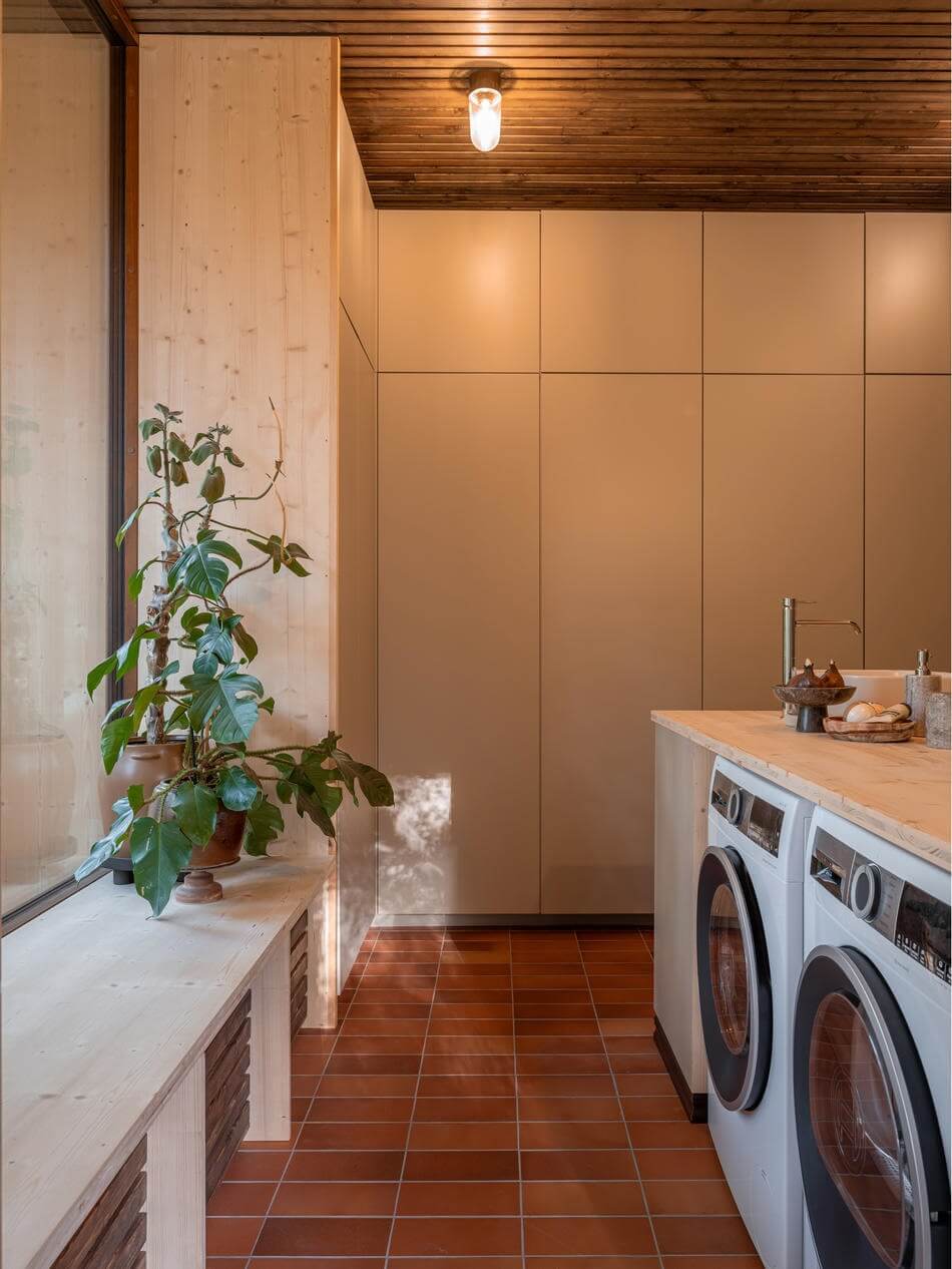 An Architectural Wooden Home with Open Spaces 19 bathroom-washer-dryer-cabinet