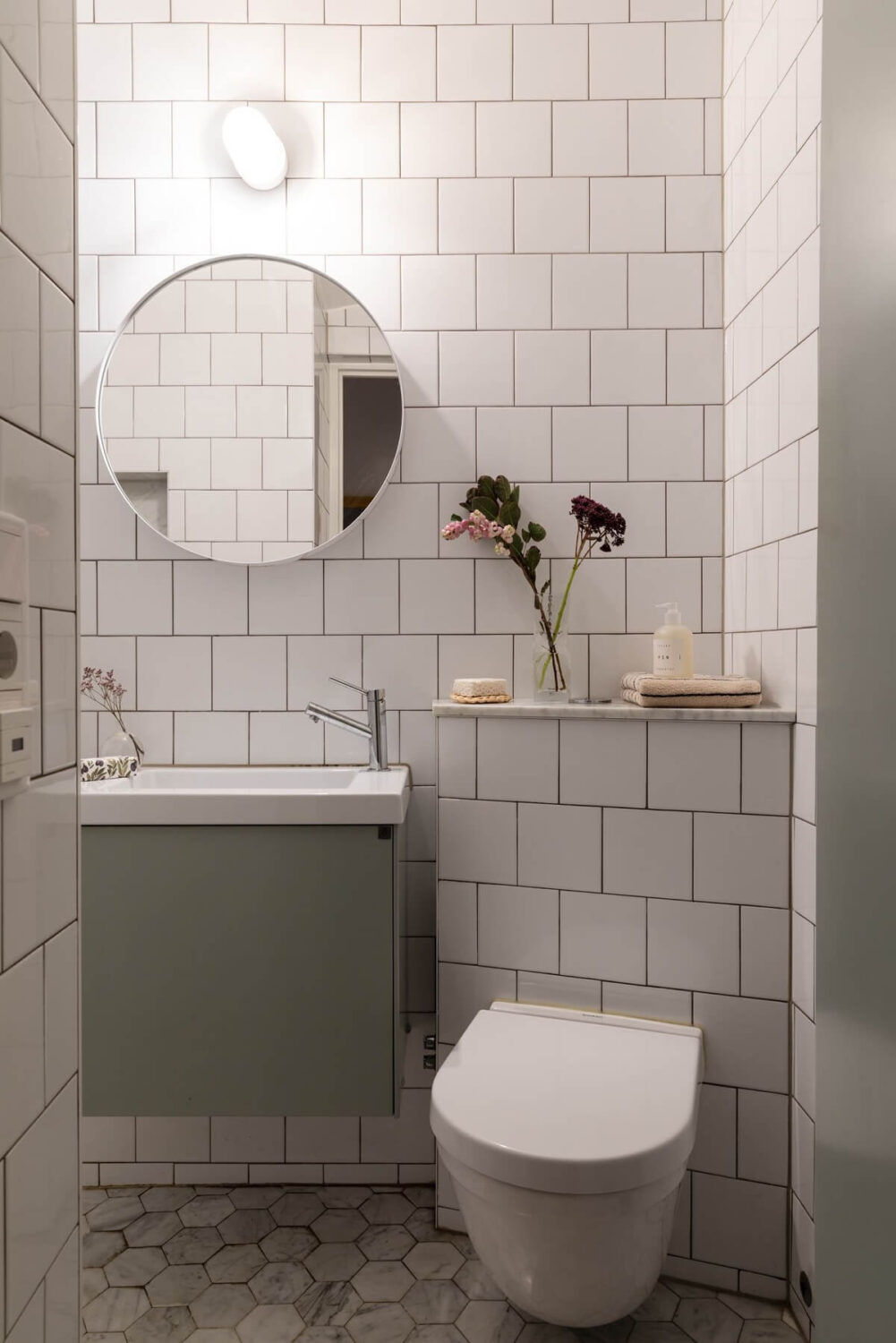 A Bright Scandinavian Apartment with a Light Gray Kitchen 24 bathroom-white-tiles-light-gray-vanity