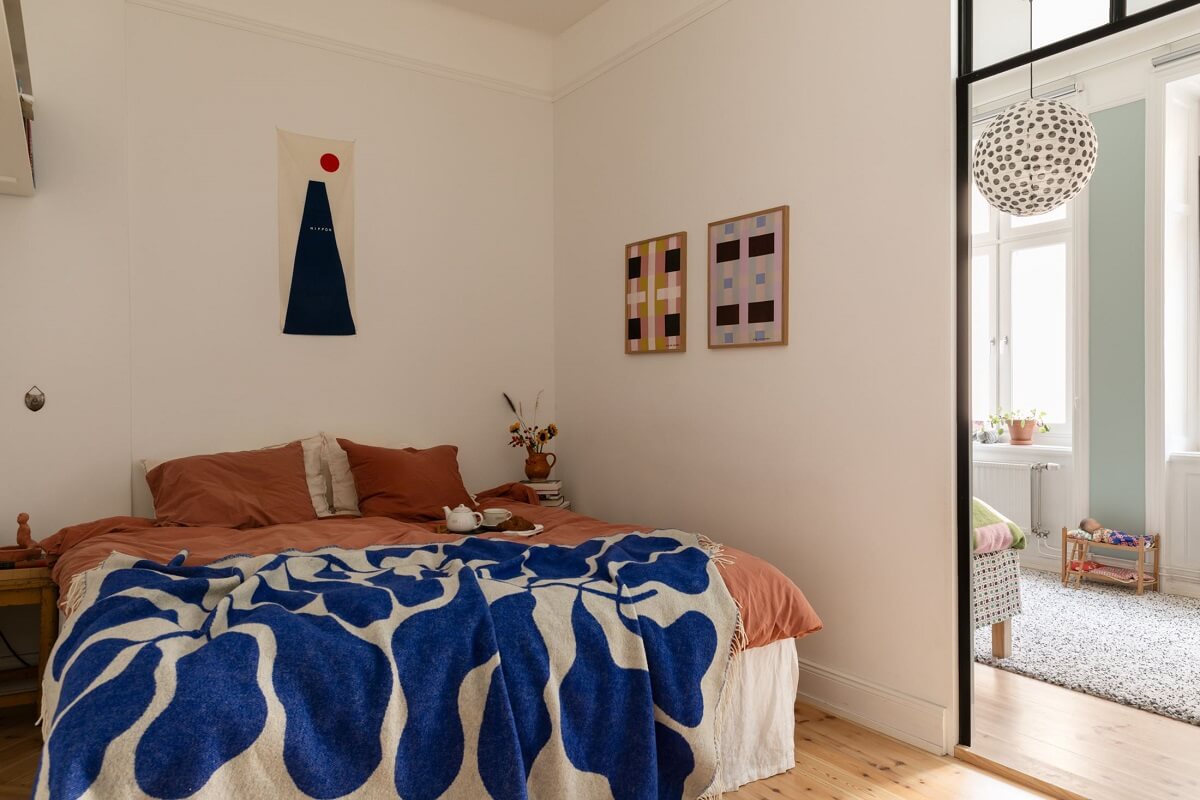 A Bright Scandinavian Apartment with a Light Gray Kitchen 19 bedroom-pink-duvet-blue-throw-industrial-glass-wall-nordroom