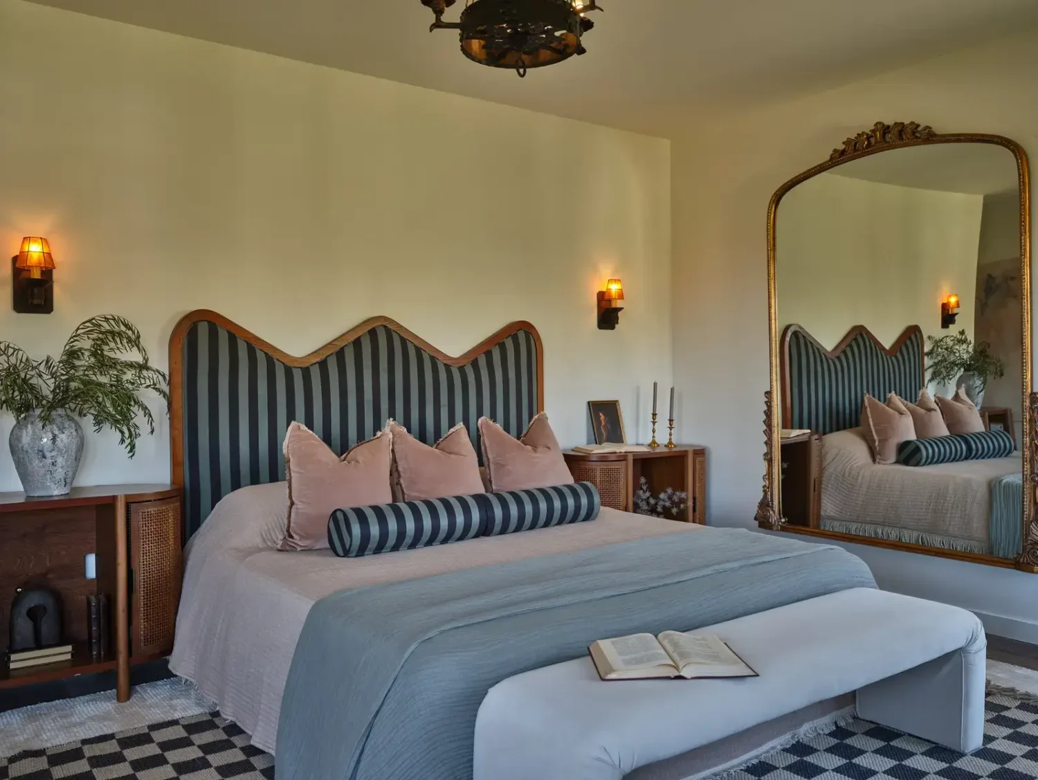 A Renovated Spanish Style Home in Hollywood Hills 23 bedroom-striped-wavy-headboard-large-antique-mirror-checkerboard-rug-nordroom
