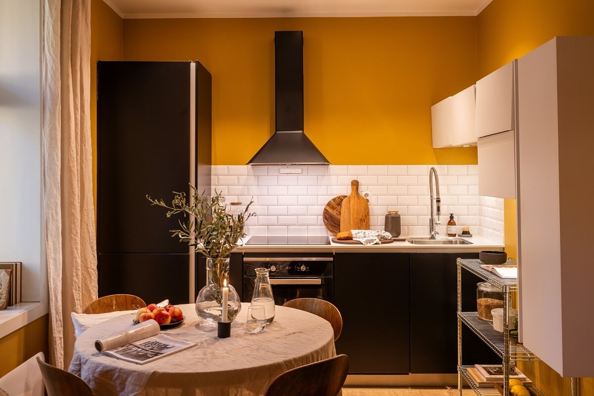 An Oslo Apartment with a Yellow Living Room 8 black-kitchen-cabinets-yellow-walls