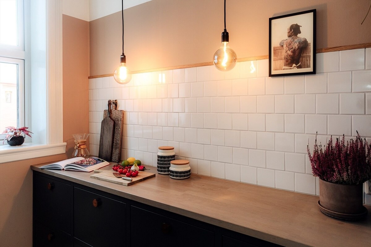 A Charming Norwegian Apartment with Wooden Walls 9 black-kitchen-white-tiles