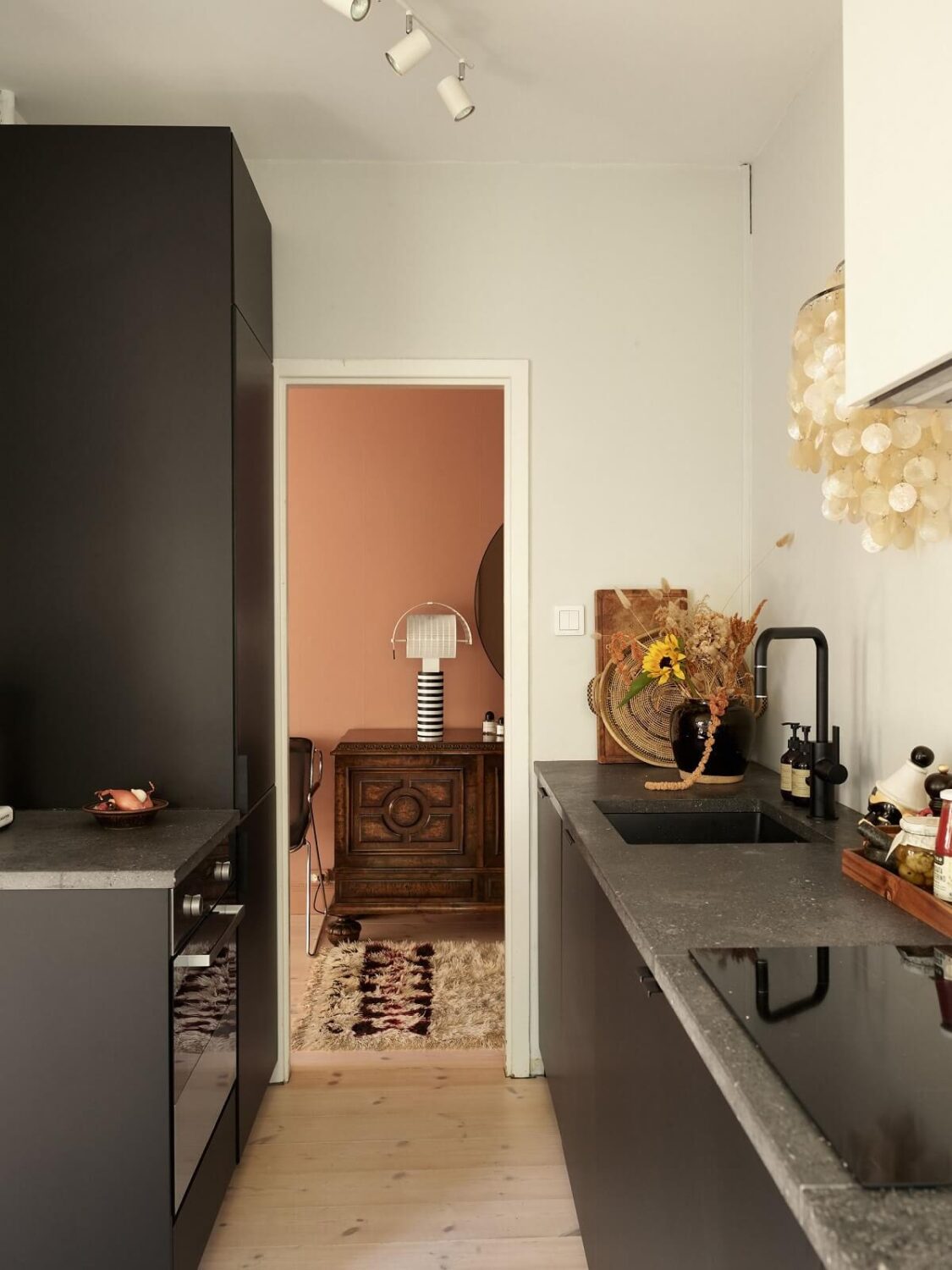 Warm Pink Tones in A Stockholm Apartment 11 black-modern-scandinavian-kitchen