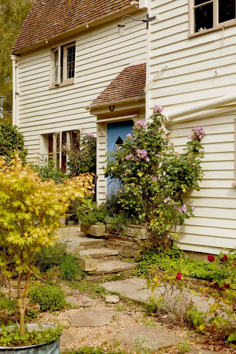 A Charming Historic Farmhouse with a Bright Yellow Kitchen 29 blue front door cottage england