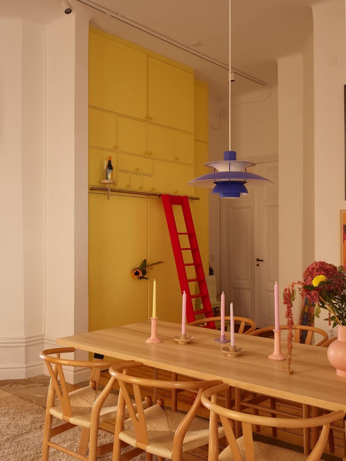 50+ Rooms That Prove ‘The Unexpected Red Theory’ Really Works 40 built-in-yellow-cabinets-with-ladder-nordroom