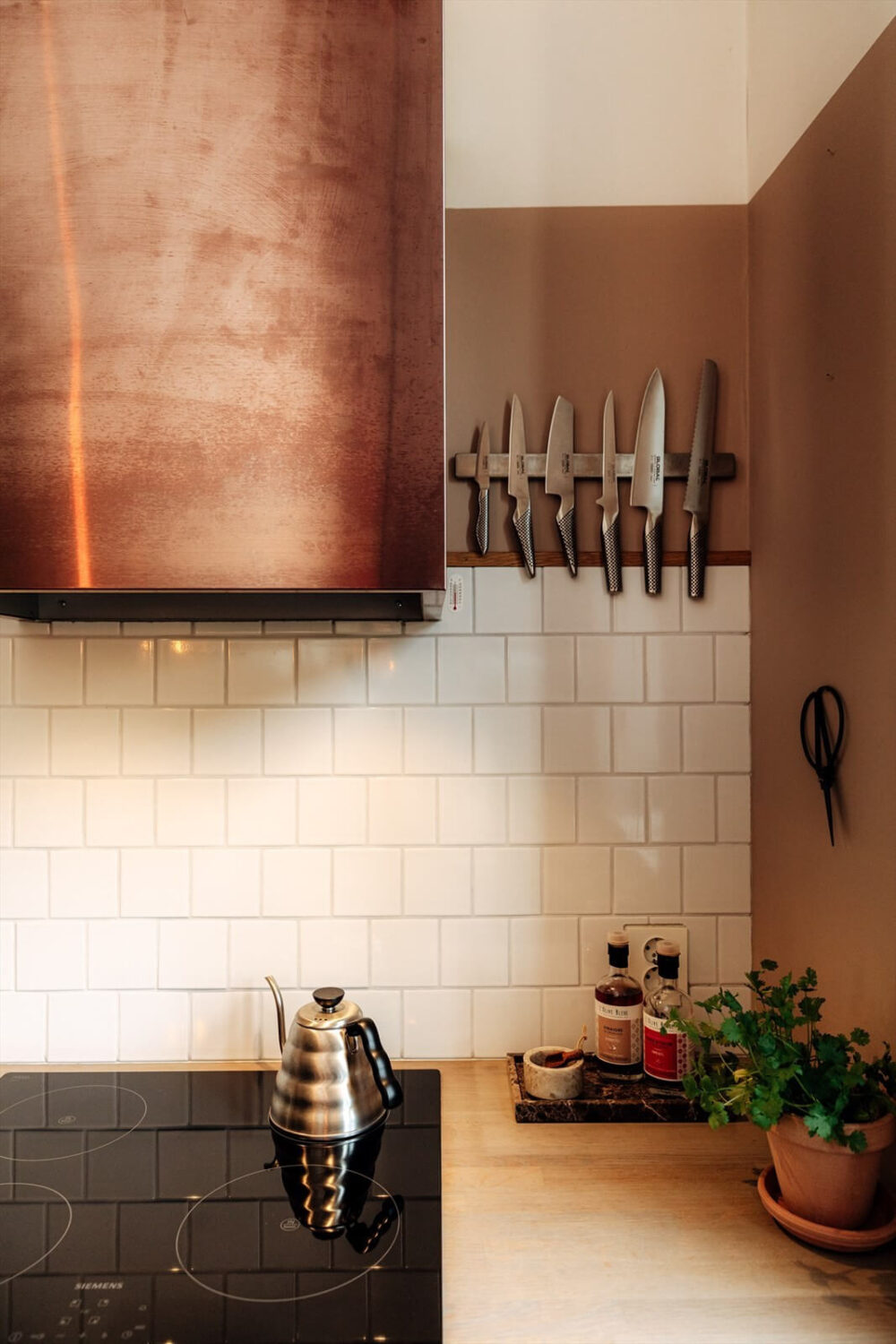 A Charming Norwegian Apartment with Wooden Walls 11 copper-hood-scandi-kitchen