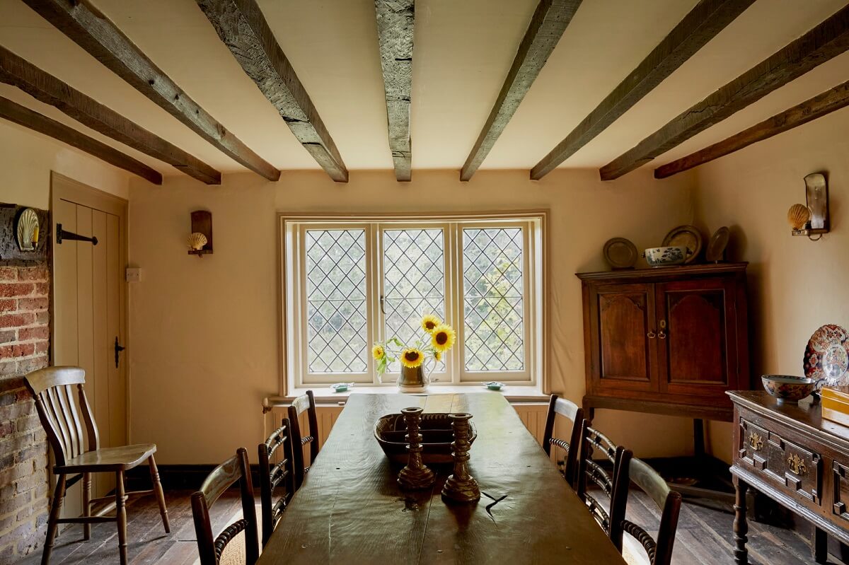 A Charming Historic Farmhouse with a Bright Yellow Kitchen 13 cottage dining room antique dining table