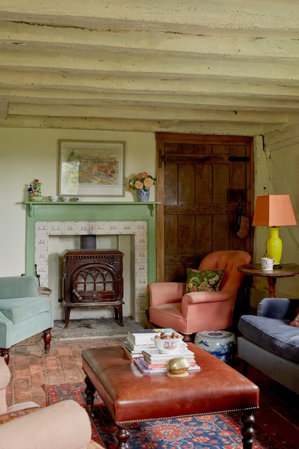 A Charming Historic Farmhouse with a Bright Yellow Kitchen 3 cozy cottage living room fireplace wooden beams