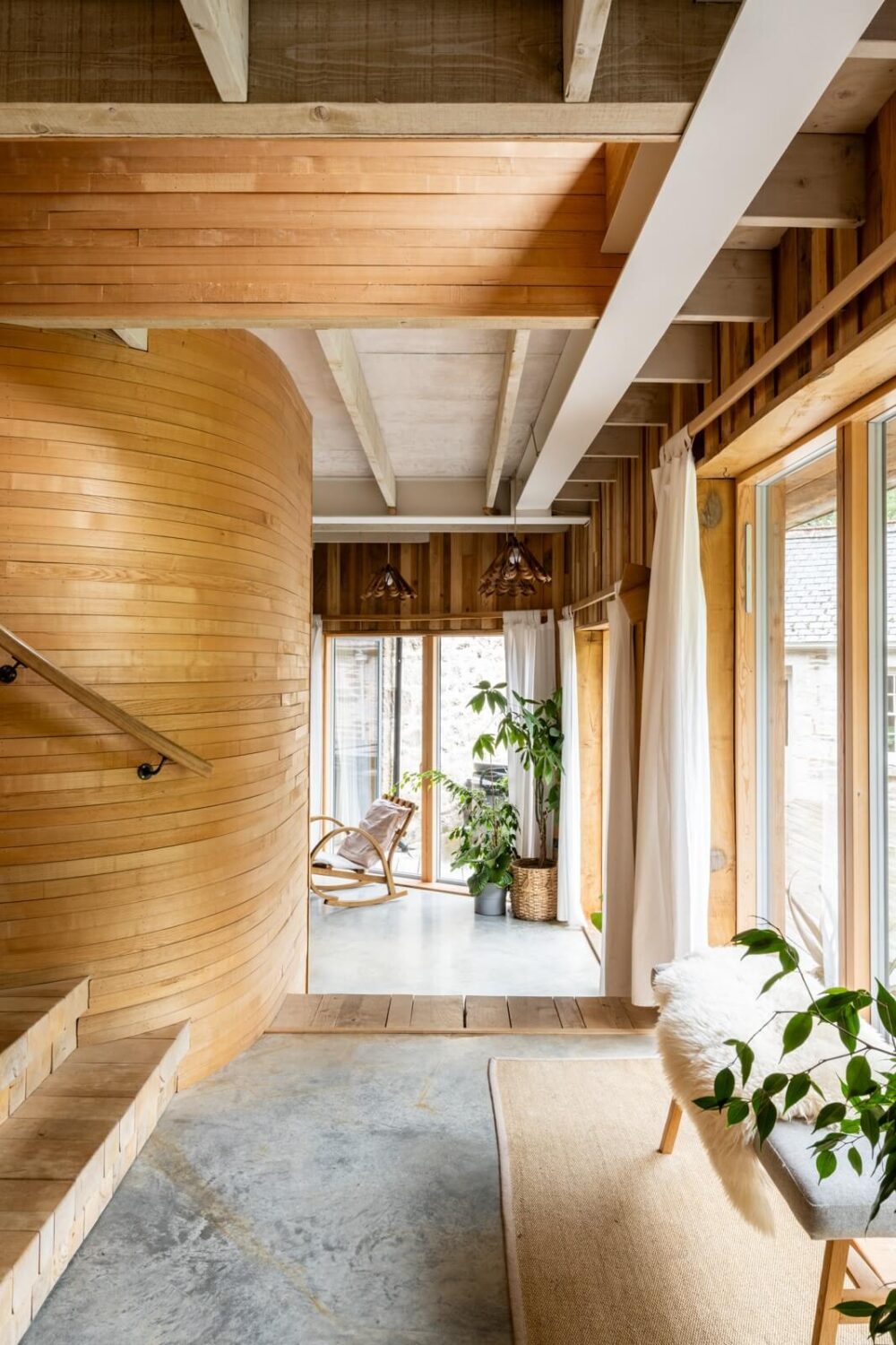 An English Country House That Pairs History with Contemporary Design 11 curved-wooden-wall-hallway-grand-designs-house-nordroom