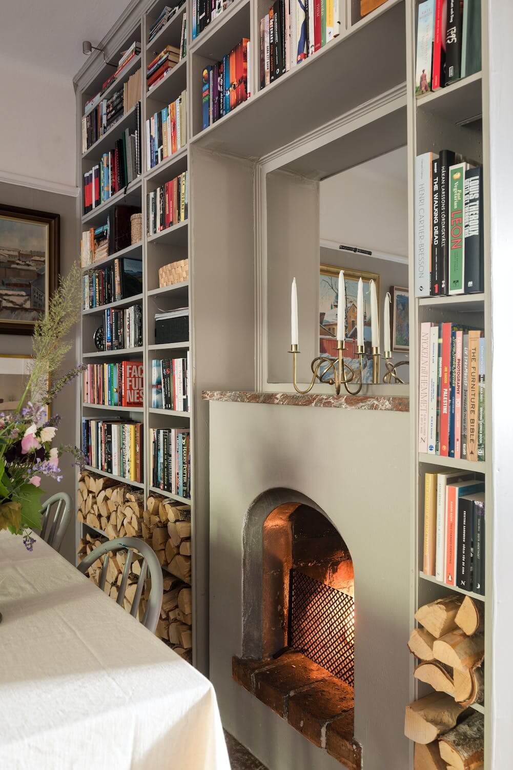A Charming Open Plan Swedish Apartment 10 dining-room-bookshelves-fireplace-nordroom