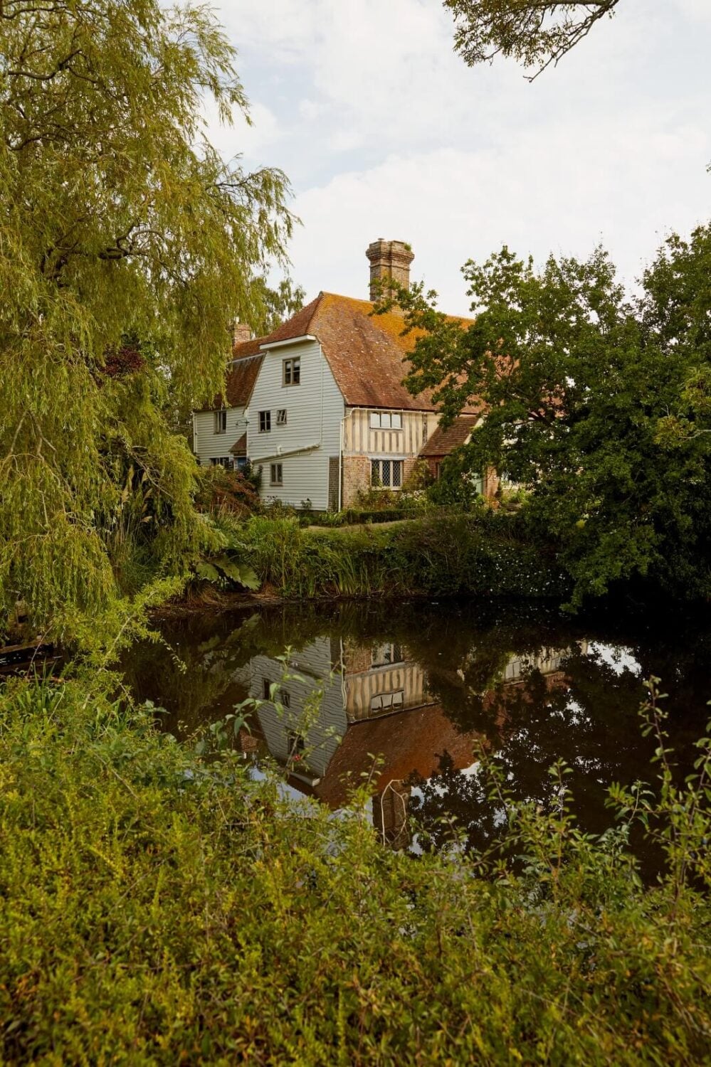 A Charming Historic Farmhouse with a Bright Yellow Kitchen 22 english country house lake